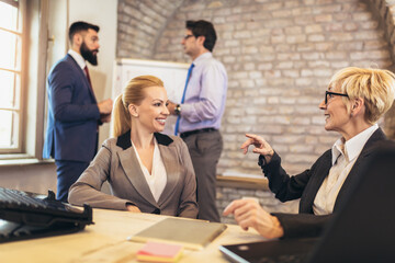 Creative diverse colleagues team discuss online project use computer at workplace