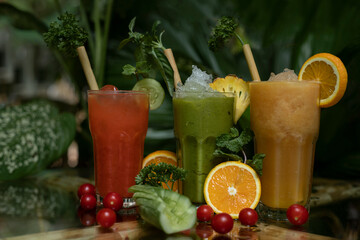 Colourful freshly squeezed fruits and vegetables smoothies with ingredients for healthy eating
