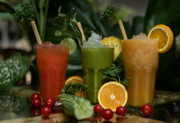 Colourful freshly squeezed fruits and vegetables smoothies with ingredients for healthy eating