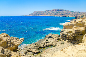 Fototapeta na wymiar Seascape, sea waves break on the rocks, Cyprus, Cape Kavo Greko