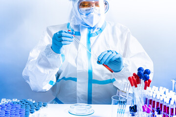 Medical laboratory with equipment and Microbiology scientist wearing ppe scrubs, face shield mask,...