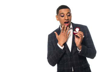 excited african american homosexual man holding jewelry box with wedding ring isolated on white