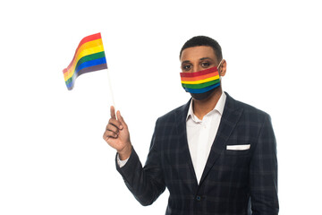 african american businessman wearing rainbow colors medical mask and holding lgbt flag isolated on...