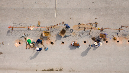Aerial top view of the workers repairing the road