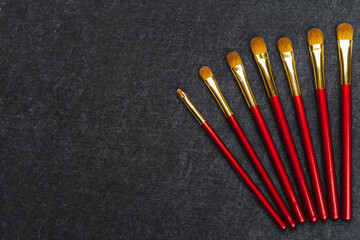 kit of makeup brushes in red coating