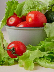 Full bowl of low calories salad with tomato, pepper, cucumber lies on scratched dark concrete. Vegetarian, dieting, healthy food. Close-up