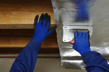Builder attaches vapor barrier membrane