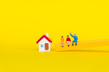 Miniature people, man and woman sitting together  on yellow background using as business meeting and social concept