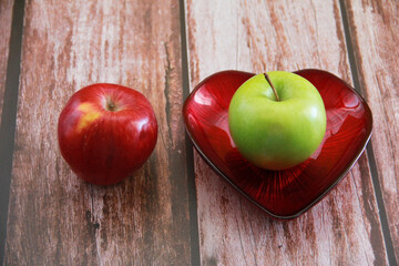 green natural apple on wooden background