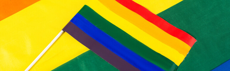 top view of lgbt flag on rainbows colors background, banner