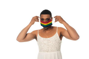 african american transvestite man putting on lgbt colors medical mask isolated on white