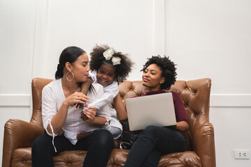 LGBT diversity Lesbian Couple Moments Happiness with her african girl laughing and drawing picture, LGBT lifestyle.