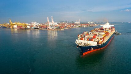 Aerial in front of smart cargo ship carrying container and running near international custom sea...
