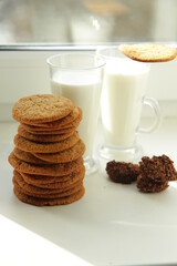 Fototapeta na wymiar Almond cookies with nuts on a wood plank. cup of milk