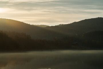 Springtime at the lake. Fog, mist and sun rays.