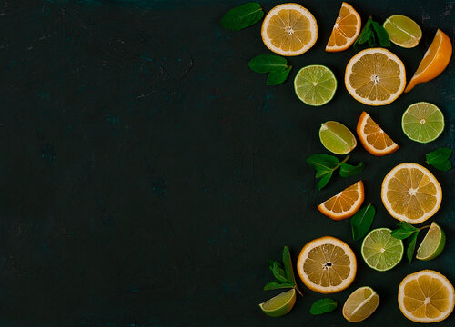 Background, Sliced Lime And Lemon, Citrus Fruit, With Mint, On A Dark Green Table, Top View, No People,