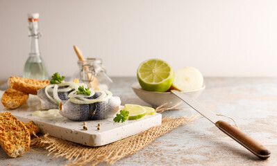 pickled herring on a plate. Seafood, pickled herring marinated in vinegar and onions on a plate....