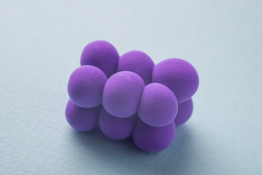closeup of a pyogenic streptococcus model, against a blue background.