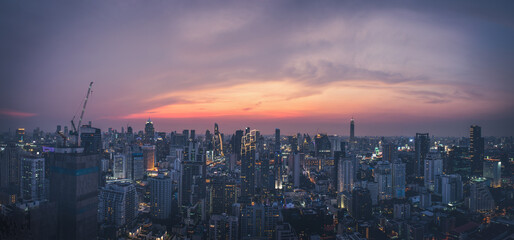 Fototapeta na wymiar Panoramic modern cityscape building bird eye aerial view to the skylne under sunset in Bangkok, Thailand. Asia Business concept for real estate.