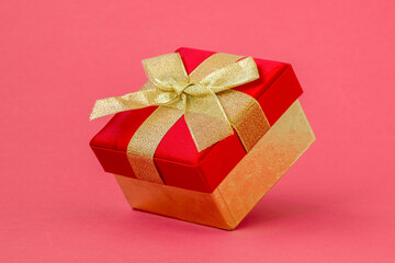 Gift box on pink paper background