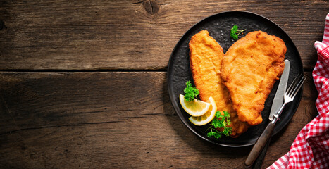 Homemade breaded wiener schnitzel served with parsley and lemon slices