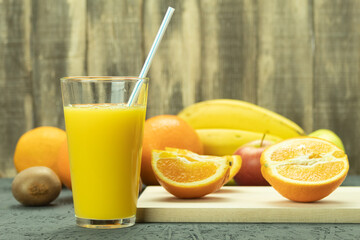 Fresh orange juice in a glass and fresh fruits