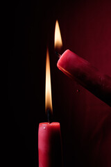 burning red candles in the dark