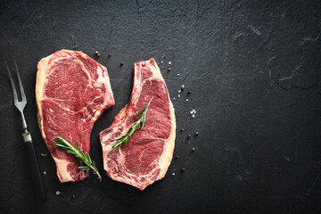 Two raw dry aged beef rib steaks (cote de boeuf)
