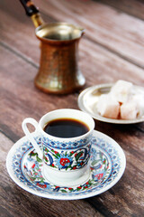 black turkish coffee in a mug and sweet lukum