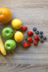Naklejka na ściany i meble Various colorful fruit on wooden background. Flat lay.
