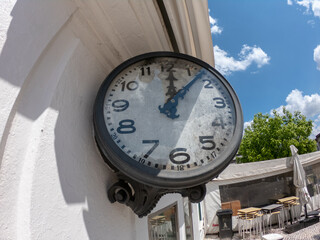 Fototapeta na wymiar Santo Tirso, Portugal - May 1, 2021: Old historical clock outdoor at the Coronel Baptista Coelho Square in the Center of Santo Tirso.