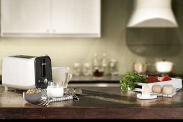 Table background of free space and white toaster. Morning time in kitchen. 