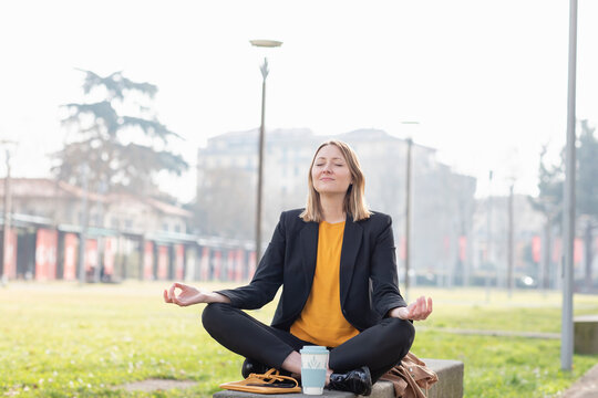 Entrepreneur meditating while sitting at park