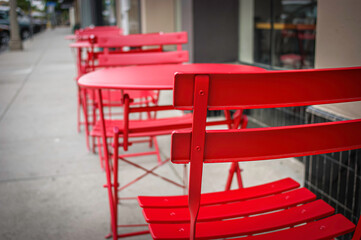Fototapeta na wymiar Outdoor dining chairs and tables on sidewalk 