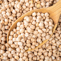 chickpea seeds in wooden spoon closeup
