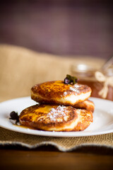 sweet fried cottage cheese pancakes with jam in a plate