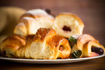 baked sweet homemade buns with plum inside