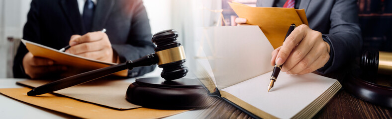 justice and law concept.Male judge in a courtroom on wooden table and Counselor or Male lawyer...