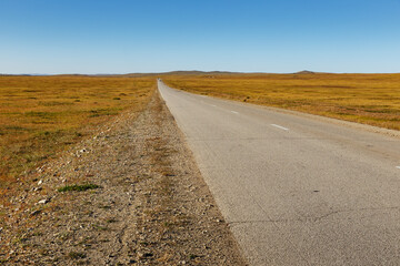 asphalt road in the Mongolian steppe, Mongolia. Bagakhangai Choir Road