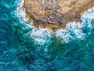 Rough sea by Alghero rocky shoreline seen from above