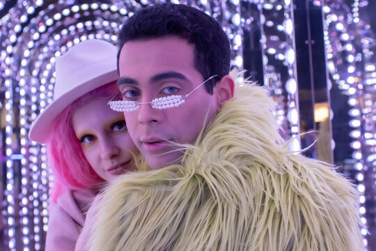 Portrait cool fashionable couple under arch lights