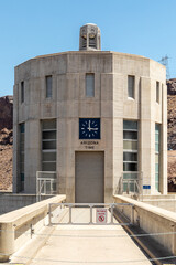 A clock on a Hoover Dam intake indicates the time on the Arizona side of the Colorado River
