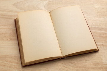 open old book on wooden table for mockup blank template