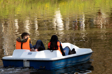 young couple riding a pedal boat