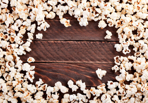 Popcorn on a wooden background. The view from top