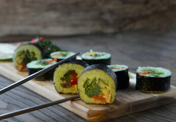 hot roll set sashimi japanese food on wooden background with lemon and chopsticks