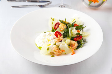 Restaurant served plate of gourmet shrimp salad on a white table