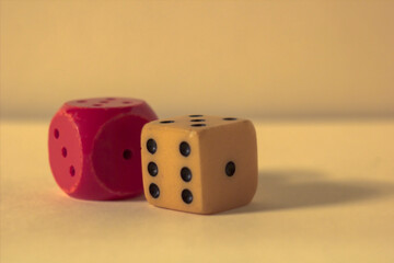 Extreme closeup macro of two dice with number 5 against plain background