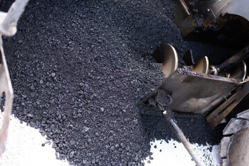 Details of industrial machinery working with asphalt, mixing bitumen with hot asphalt, layering on...