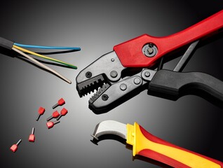 A crimping tool for an electrician on a dark background.